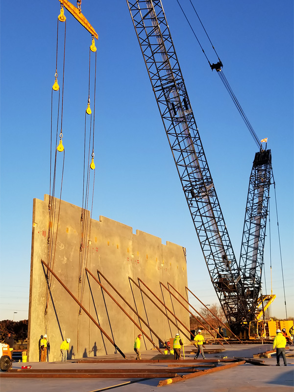Crane Installing Precast Concrete Building Wall
